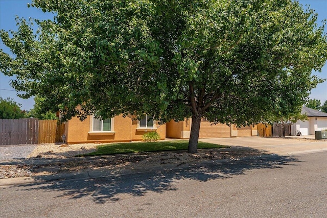 2236 Lonigan Ct, Redding, CA 96001 - view of property hidden behind natural elements featuring driveway and stucco siding