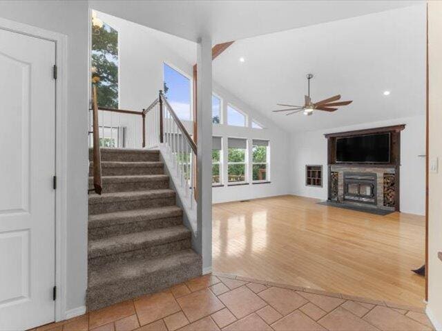 15540 China Rapids Dr, Red Bluff, CA 96080 - stairs featuring a ceiling fan, a fireplace, lofted ceiling, and recessed lighting