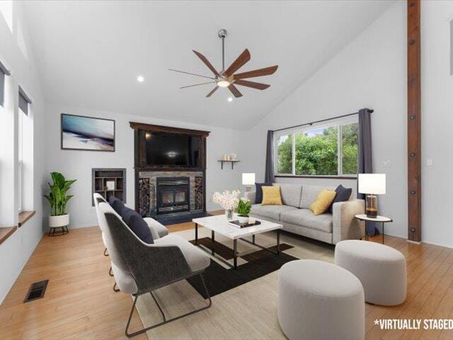 15540 China Rapids Dr, Red Bluff, CA 96080 - living room with a glass covered fireplace, high vaulted ceiling, ceiling fan, light wood finished floors, and recessed lighting