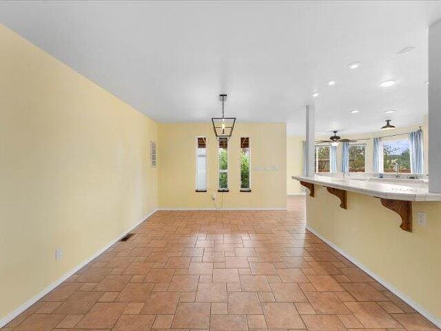 15540 China Rapids Dr, Red Bluff, CA 96080 - unfurnished room with light stone finish flooring and ceiling fan
