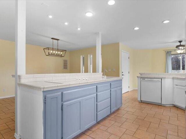 15540 China Rapids Dr, Red Bluff, CA 96080 - kitchen with white dishwasher, tile counters, recessed lighting, hanging light fixtures, and ceiling fan