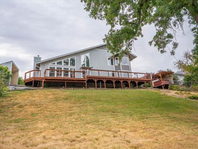 15540 China Rapids Dr, Red Bluff, CA 96080 - rear view of property featuring a yard, a deck, and a chimney