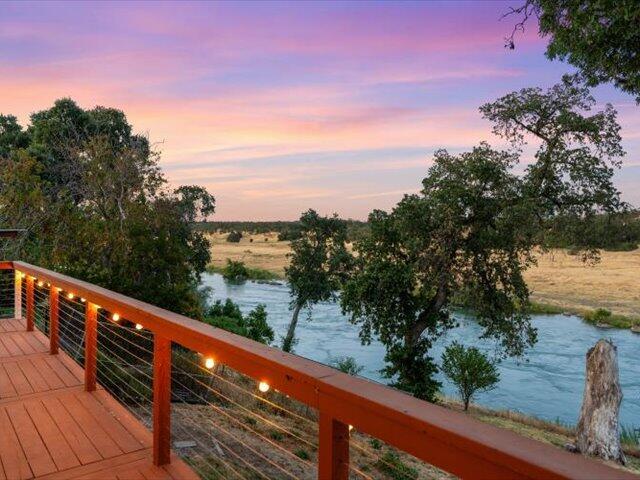 15540 China Rapids Dr, Red Bluff, CA 96080 - deck at dusk featuring a water view