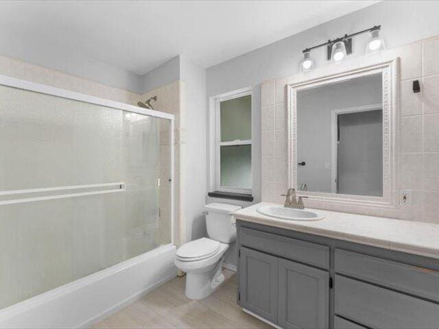 15540 China Rapids Dr, Red Bluff, CA 96080 - full bathroom featuring vanity, tile walls, combined bath / shower with glass door, and tile patterned floors