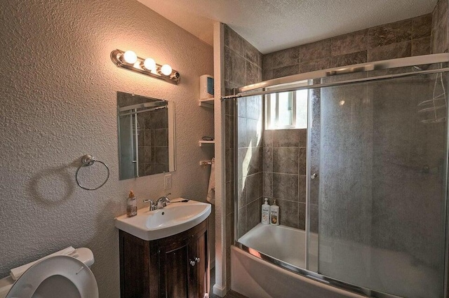 21657 W Elk Trl, Redding, CA 96003 - bathroom with a textured wall, vanity, enclosed tub / shower combo, and a textured ceiling