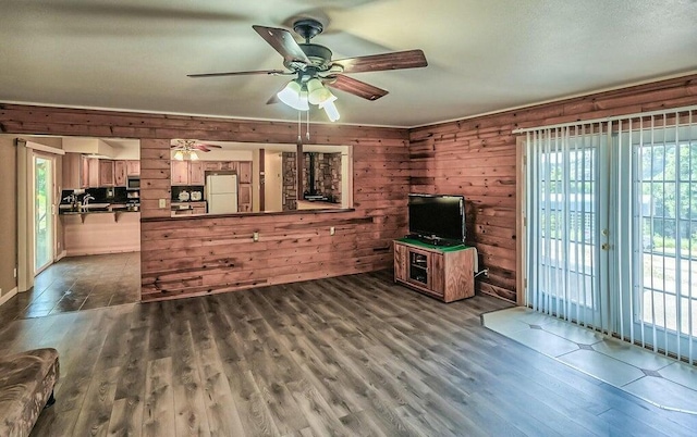 21657 W Elk Trl, Redding, CA 96003 - unfurnished living room featuring wood finished floors, ceiling fan, and wood walls