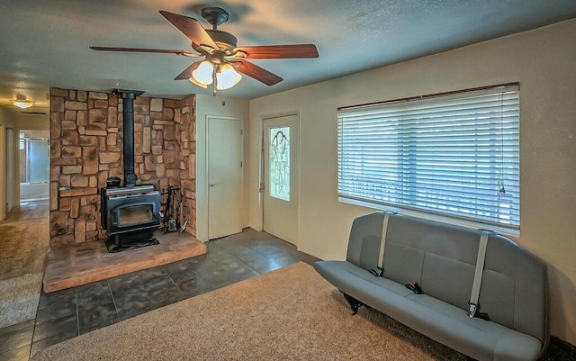 21657 W Elk Trl, Redding, CA 96003 - tiled living room with a wood stove and a ceiling fan