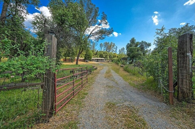 21657 W Elk Trl, Redding, CA 96003 - view of dirt / gravel road with a gated entry