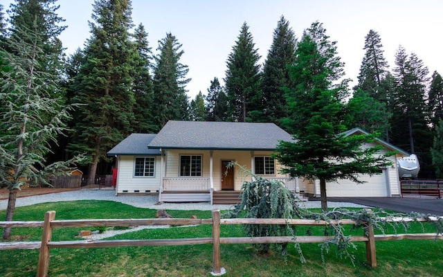 35363 Nehemiah Dr, Shingletown, CA 96088 - view of front of home with covered porch, driveway, a fenced front yard, a garage, and a shingled roof