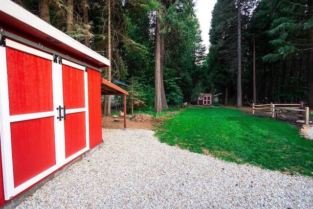 35363 Nehemiah Dr, Shingletown, CA 96088 - view of green lawn featuring a storage shed and a view of trees