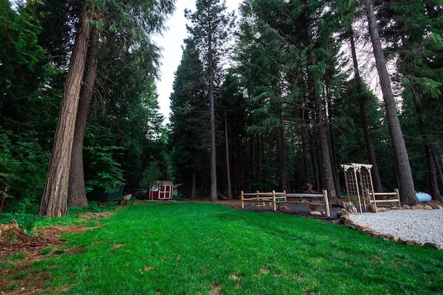 35363 Nehemiah Dr, Shingletown, CA 96088 - view of green lawn featuring a shed and a wooded view