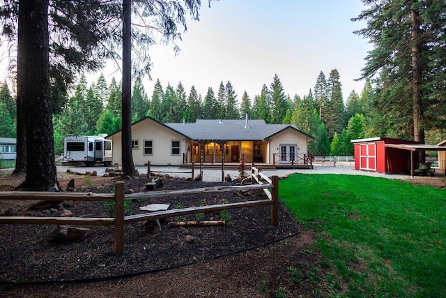 35363 Nehemiah Dr, Shingletown, CA 96088 - back of property featuring french doors, a view of trees, and a storage unit