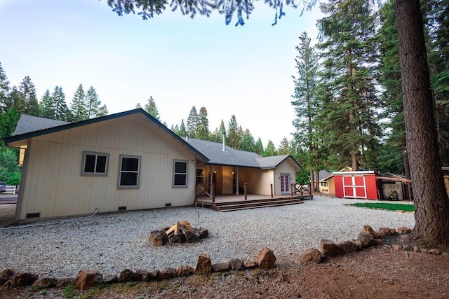 35363 Nehemiah Dr, Shingletown, CA 96088 - back of house with a fire pit, a deck, crawl space, and a shed