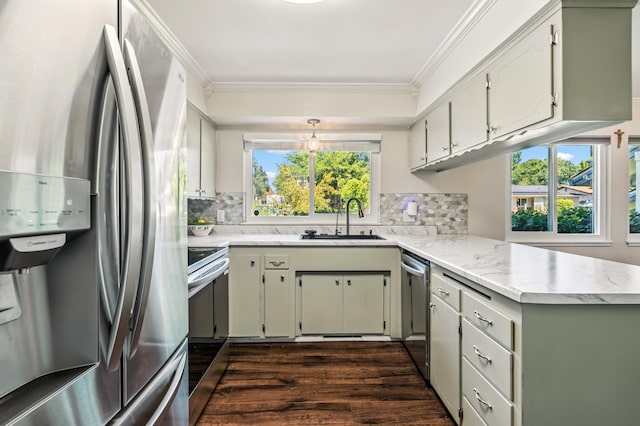 3442 Thomas Ave, Anderson, CA 96007 - kitchen featuring appliances with stainless steel finishes, ornamental molding, backsplash, a peninsula, and dark wood-type flooring