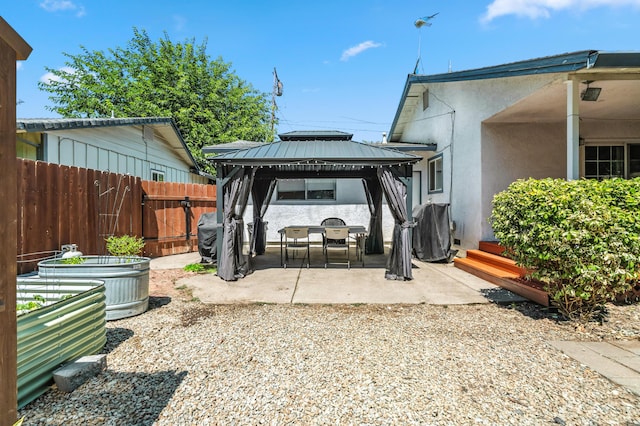 3442 Thomas Ave, Anderson, CA 96007 - back of property with stucco siding, a gazebo, a patio area, a metal roof, and a gate