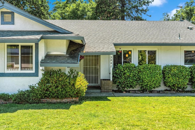 3442 Thomas Ave, Anderson, CA 96007 - view of front of house with a shingled roof, stucco siding, and a front yard