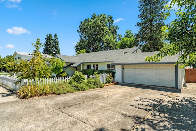 3442 Thomas Ave, Anderson, CA 96007 - single story home with driveway, a garage, a fenced front yard, a shingled roof, and stucco siding