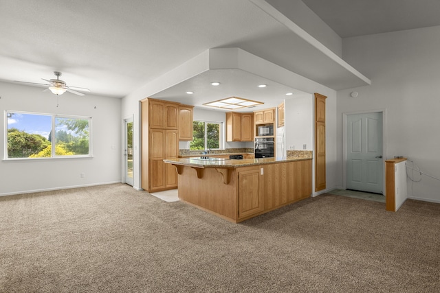 19258 Granola Way, Cottonwood, CA 96022 - kitchen featuring black appliances, light colored carpet, a peninsula, a kitchen bar, and ceiling fan