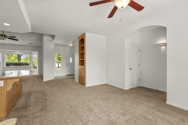 19258 Granola Way, Cottonwood, CA 96022 - unfurnished living room with a ceiling fan, light carpet, and arched walkways