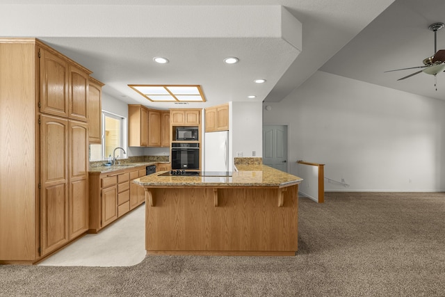19258 Granola Way, Cottonwood, CA 96022 - kitchen with black appliances, light colored carpet, a kitchen breakfast bar, recessed lighting, and light stone counters