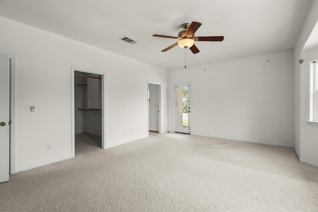 19258 Granola Way, Cottonwood, CA 96022 - unfurnished bedroom with light colored carpet, a walk in closet, and ceiling fan