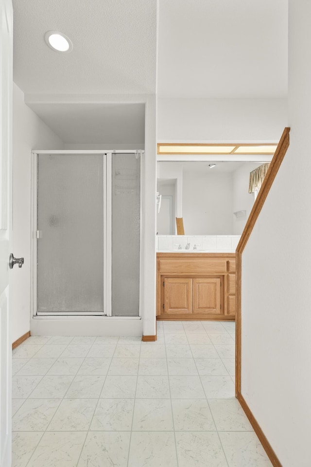 19258 Granola Way, Cottonwood, CA 96022 - bathroom with marble look tile flooring, a shower stall, and vanity