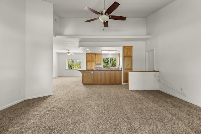 19258 Granola Way, Cottonwood, CA 96022 - unfurnished living room with a ceiling fan, light carpet, and a high ceiling