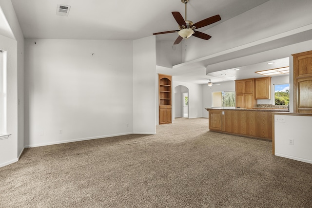 19258 Granola Way, Cottonwood, CA 96022 - unfurnished living room with a ceiling fan, arched walkways, light carpet, and high vaulted ceiling