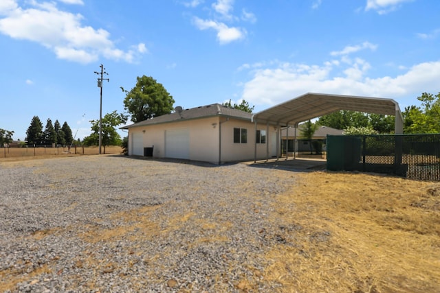 19258 Granola Way, Cottonwood, CA 96022 - view of side of home with stucco siding, a garage, and a carport