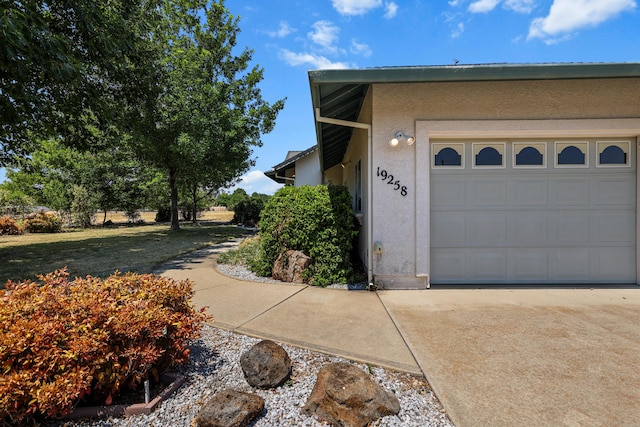 19258 Granola Way, Cottonwood, CA 96022 - view of property exterior featuring stucco siding, concrete driveway, and an attached garage