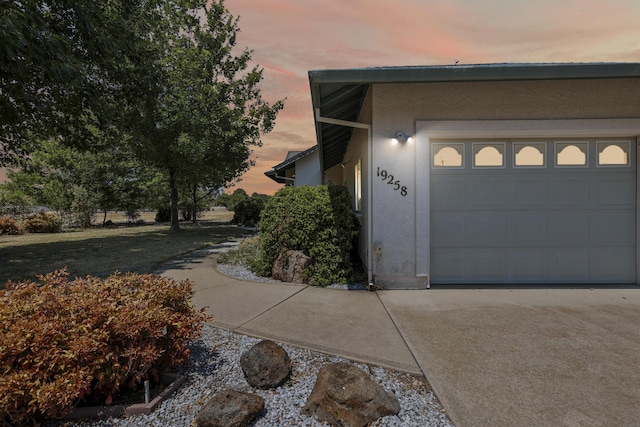 19258 Granola Way, Cottonwood, CA 96022 - view of property exterior with stucco siding, concrete driveway, and an attached garage