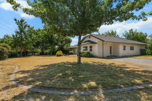19258 Granola Way, Cottonwood, CA 96022 - view of side of property featuring a yard and stucco siding