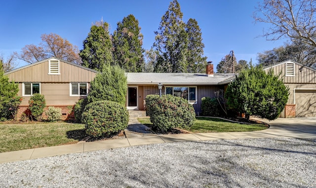 3283 Middleton Ln, Redding, CA 96002 - ranch-style home with a chimney, brick siding, a front yard, and driveway
