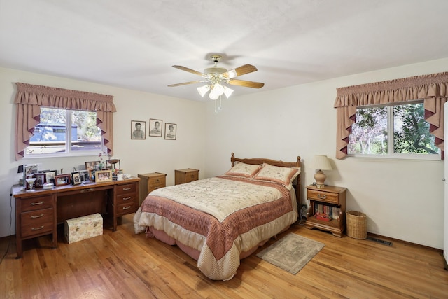 3283 Middleton Ln, Redding, CA 96002 - bedroom with light wood-style floors, multiple windows, and a ceiling fan