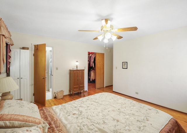 3283 Middleton Ln, Redding, CA 96002 - bedroom with light wood-type flooring, a spacious closet, and ceiling fan