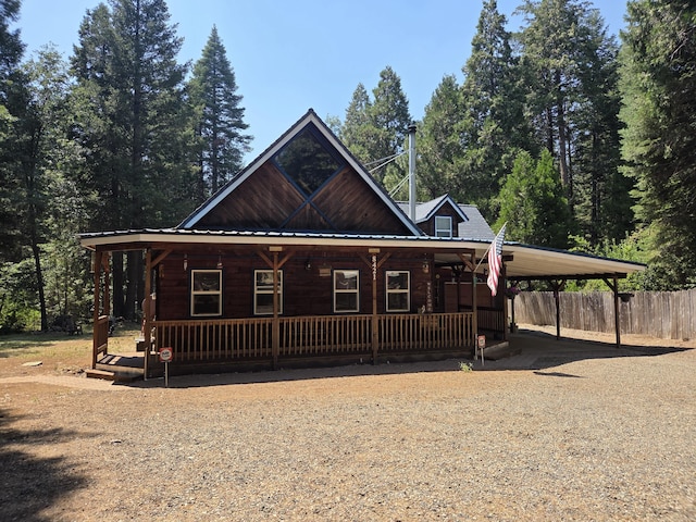 8421 Starlite Pines Rd, Shingletown, CA 96088 - view of front of house with covered porch, a carport, driveway, and a metal roof