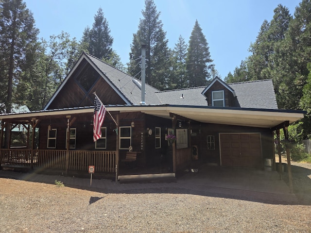 8421 Starlite Pines Rd, Shingletown, CA 96088 - view of front of property with covered porch, a carport, driveway, a garage, and a shingled roof
