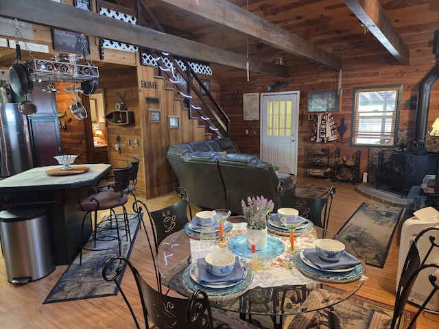 8421 Starlite Pines Rd, Shingletown, CA 96088 - dining room with a wood stove, wooden walls, wood finished floors, and wooden ceiling