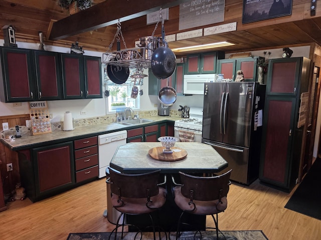8421 Starlite Pines Rd, Shingletown, CA 96088 - kitchen with white appliances, light wood finished floors, a wooden ceiling with exposed beams, and light countertops