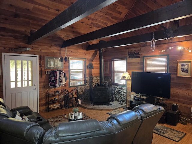 8421 Starlite Pines Rd, Shingletown, CA 96088 - living room with wood walls, wood finished floors, a wood stove, and a wooden ceiling with exposed beams