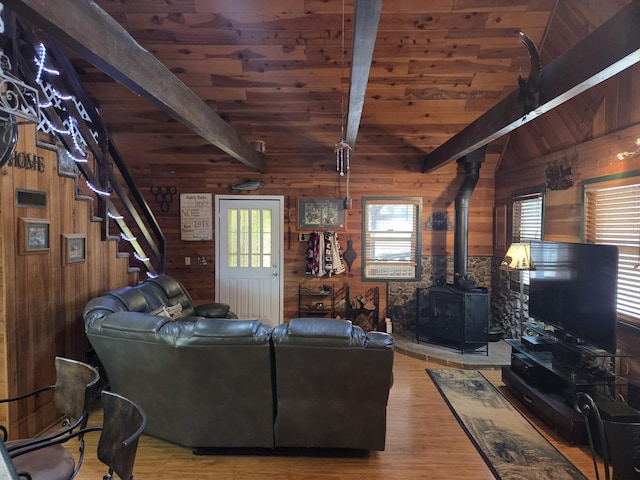 8421 Starlite Pines Rd, Shingletown, CA 96088 - living area featuring wood walls, a wood ceiling with exposed beams, wood finished floors, a wood stove, and stairs