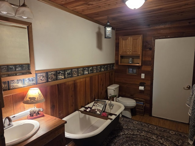 8421 Starlite Pines Rd, Shingletown, CA 96088 - full bath with a freestanding bath, wooden walls, wood ceiling, a wainscoted wall, and vanity