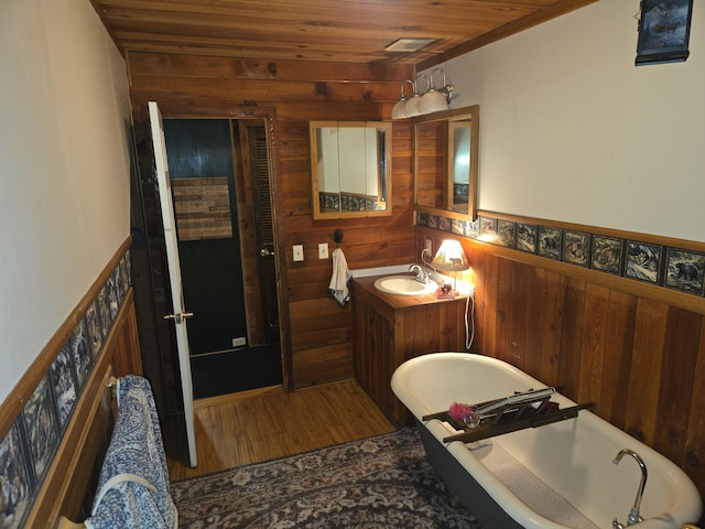 8421 Starlite Pines Rd, Shingletown, CA 96088 - full bathroom with a freestanding tub, wooden walls, wooden ceiling, vanity, and wood finished floors