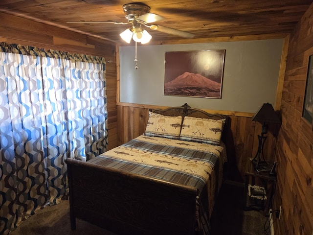 8421 Starlite Pines Rd, Shingletown, CA 96088 - carpeted bedroom with wood walls, wood ceiling, wainscoting, and a ceiling fan