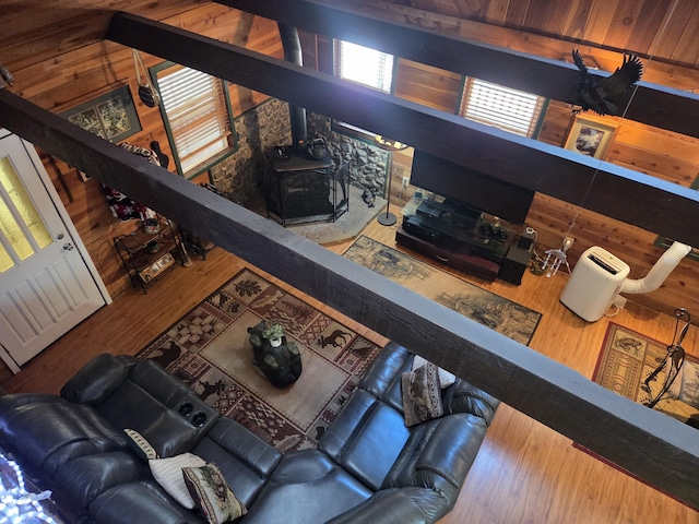 8421 Starlite Pines Rd, Shingletown, CA 96088 - living room featuring a wood stove, wood walls, and wood finished floors