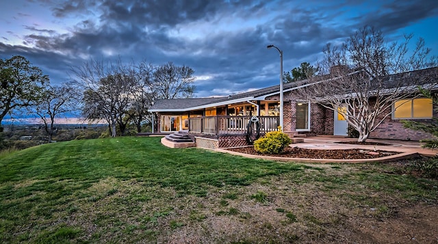 21790 Adobe Rd, Red Bluff, CA 96080 - rear view of house with a chimney, a yard, and brick siding
