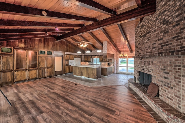 21790 Adobe Rd, Red Bluff, CA 96080 - unfurnished living room featuring dark wood-style flooring, a chandelier, wooden ceiling, a fireplace, and ceiling fan