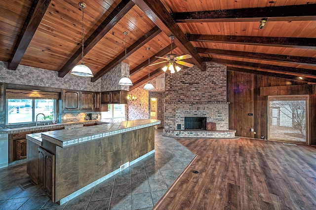 21790 Adobe Rd, Red Bluff, CA 96080 - kitchen featuring dark brown cabinetry, wood ceiling, a fireplace, open floor plan, and ceiling fan