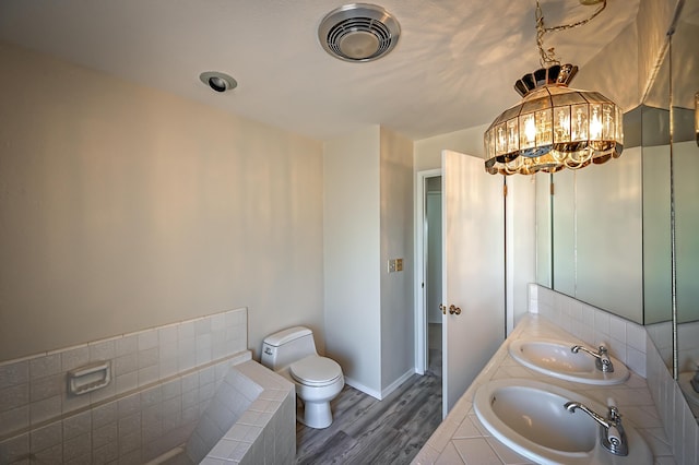 21790 Adobe Rd, Red Bluff, CA 96080 - full bath featuring wood finished floors, double vanity, and tiled tub
