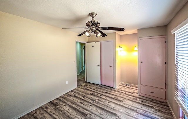 21790 Adobe Rd, Red Bluff, CA 96080 - unfurnished bedroom with wood finished floors, a ceiling fan, and a textured ceiling